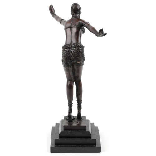 1005 - Patinated bronze figurine of an Art Deco female raised on a black marble stepped base, 41cm high