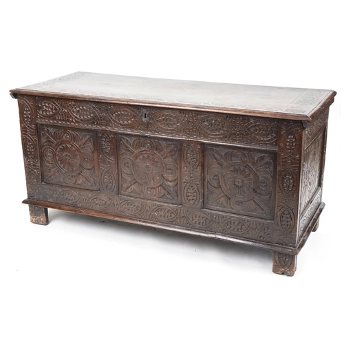 660 - Late 18th century and later oak triple panel coffer profusely carved, 73cm H x 147cm W x 58cm D