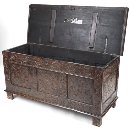 660 - Late 18th century and later oak triple panel coffer profusely carved, 73cm H x 147cm W x 58cm D