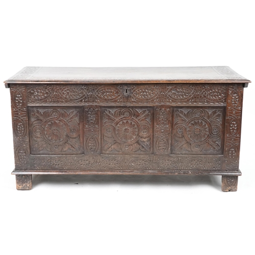 660 - Late 18th century and later oak triple panel coffer profusely carved, 73cm H x 147cm W x 58cm D