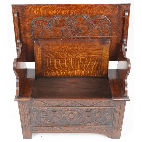 665 - Late Victorian oak monk's bench, the box seat above a carved panel front, 74cm H x 87cm W x 43cm D