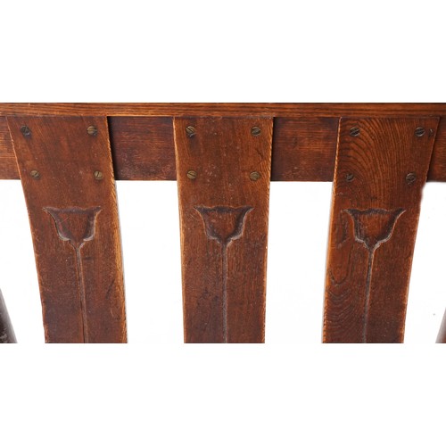 531 - Early 20th century Arts & Crafts oak two seat bench, probably by William Birch, the carved splat bac... 