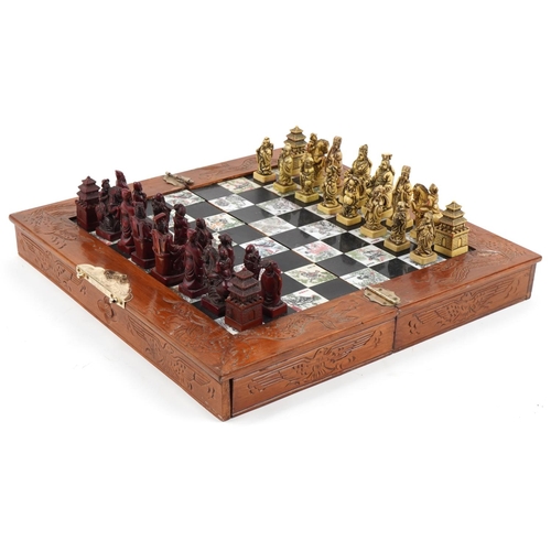 2328 - Chinese hardwood folding chess set, 36cm x 36cm