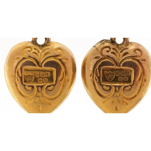 3323 - Two 9ct gold engraved love heart charms, each 1.3cm high, total 0.9g