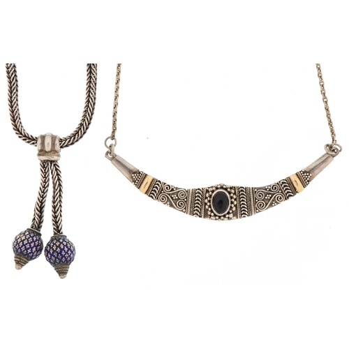 3485 - Two silver necklaces, one with blue enamel tassels, the other set with a cabochon amethyst, total 42... 