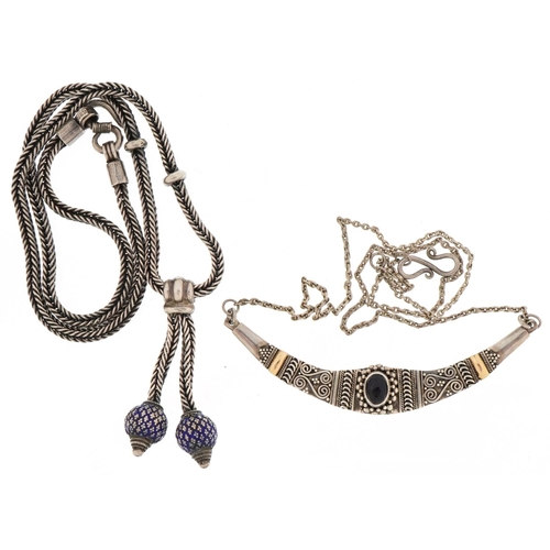 3485 - Two silver necklaces, one with blue enamel tassels, the other set with a cabochon amethyst, total 42... 