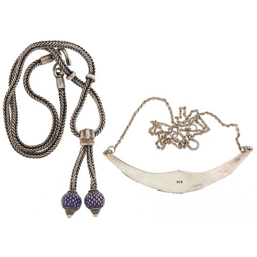 3485 - Two silver necklaces, one with blue enamel tassels, the other set with a cabochon amethyst, total 42... 