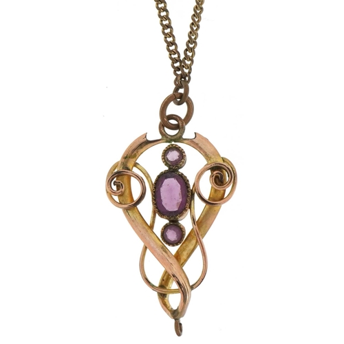 3100 - Edwardian yellow metal openwork pendant on chain set with purple stones, 3.6cm high and 44cm in leng... 