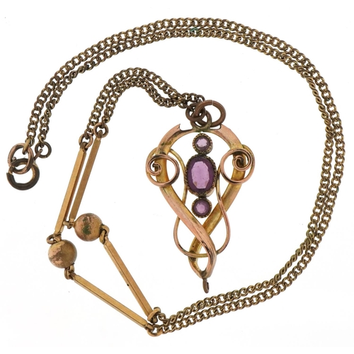 3100 - Edwardian yellow metal openwork pendant on chain set with purple stones, 3.6cm high and 44cm in leng... 