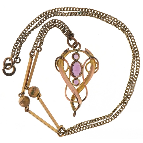 3100 - Edwardian yellow metal openwork pendant on chain set with purple stones, 3.6cm high and 44cm in leng... 