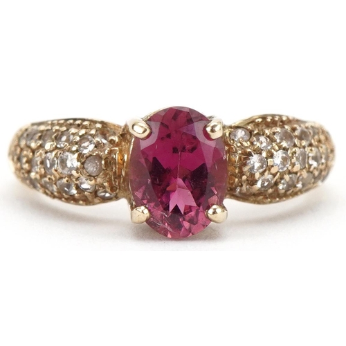 3228 - 9ct gold garnet solitaire ring, the shoulders set with white spinels, size N, 3.8g