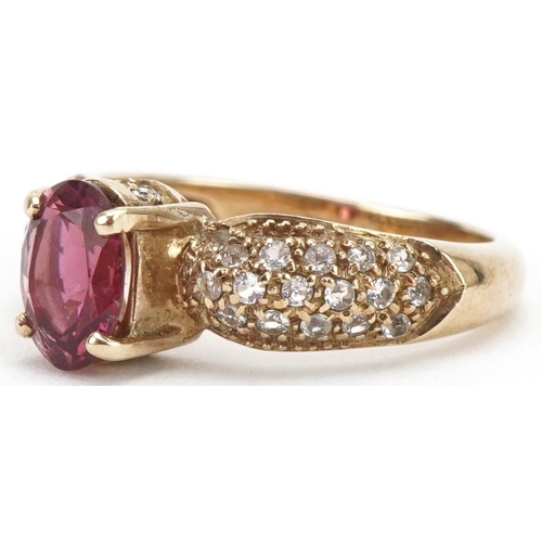 3228 - 9ct gold garnet solitaire ring, the shoulders set with white spinels, size N, 3.8g