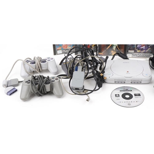 2378 - PlayStation 1 games console with controllers and accessories and a collection of games including Ray... 