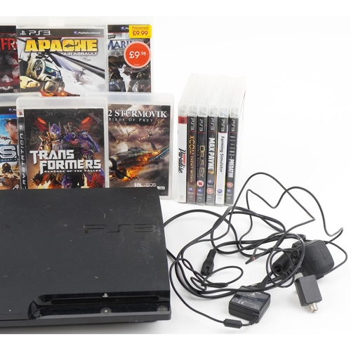 2375 - Sony PlayStation 3 games console with controllers and a collection of games