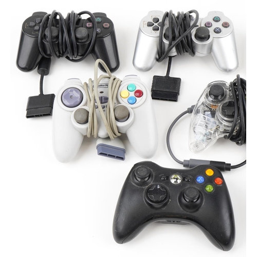 2372 - Collection of PlayStation and Xbox games console controllers