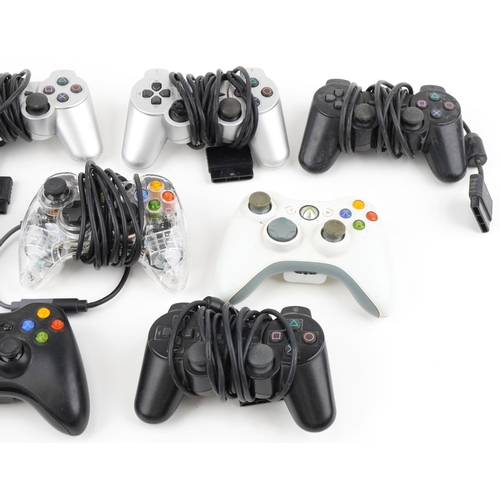 2372 - Collection of PlayStation and Xbox games console controllers