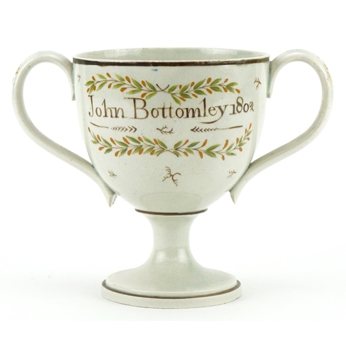 1093 - Pearlware loving cup decorated in the Chinese manner inscribed John Bottomley 1802, 13cm high