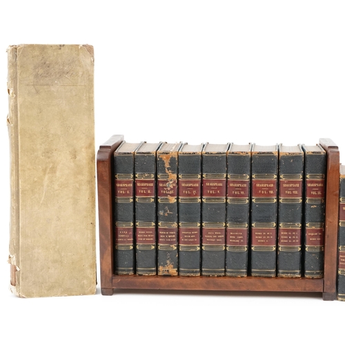 1590 - Fifteen volumes of Shakespeare 1834 edition housed in a wooden bookshelf and a Victorian ledger, the... 