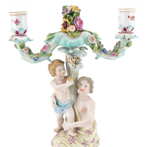 1102 - Continental porcelain floral encrusted candelabra of a mother and child, impressed number 123 to the... 