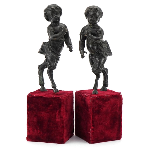 1004 - Pair of bronze fauns mounted on wooden velvet lined bases, each 38cm high