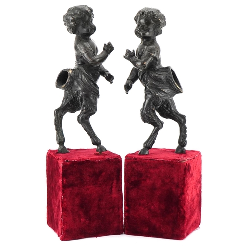 1004 - Pair of bronze fauns mounted on wooden velvet lined bases, each 38cm high