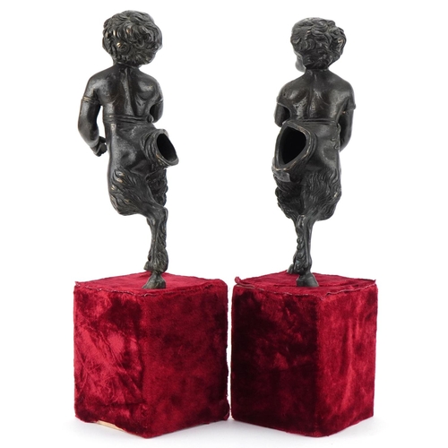 1004 - Pair of bronze fauns mounted on wooden velvet lined bases, each 38cm high