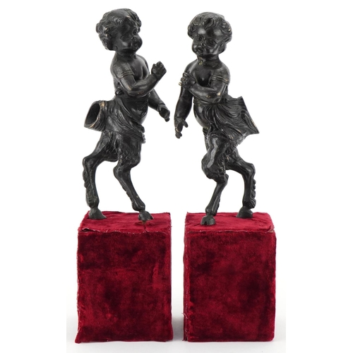 1004 - Pair of bronze fauns mounted on wooden velvet lined bases, each 38cm high