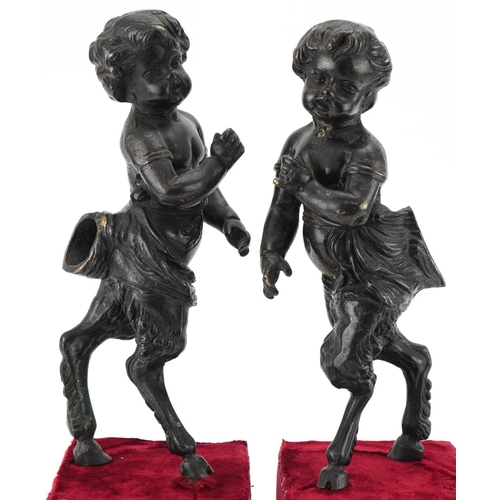 1004 - Pair of bronze fauns mounted on wooden velvet lined bases, each 38cm high