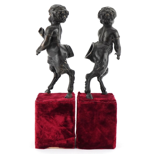 1004 - Pair of bronze fauns mounted on wooden velvet lined bases, each 38cm high