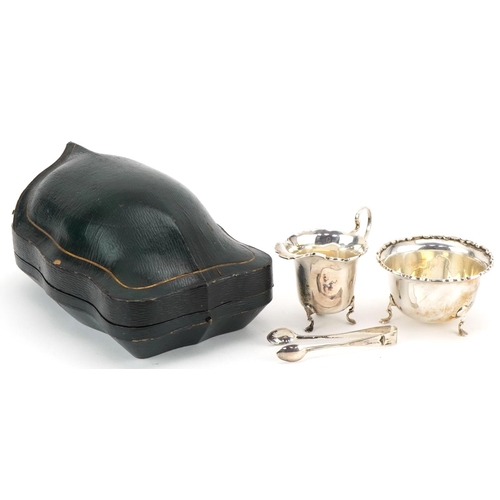 1078 - Mappin & Webb, George V silver cream jug, sugar bowl and sugar tongs housed in a velvet and silk lin... 