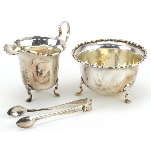 1078 - Mappin & Webb, George V silver cream jug, sugar bowl and sugar tongs housed in a velvet and silk lin... 