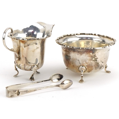 1078 - Mappin & Webb, George V silver cream jug, sugar bowl and sugar tongs housed in a velvet and silk lin... 