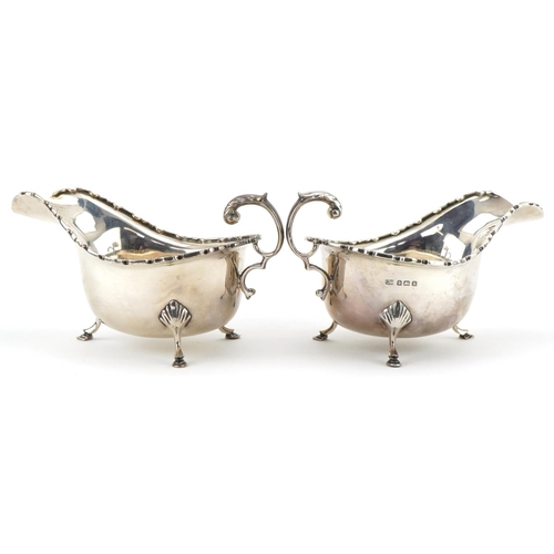 1029 - Charles Weale, pair of George V silver sauceboats raised on three hoof feet, Birmingham 1925, each 1... 