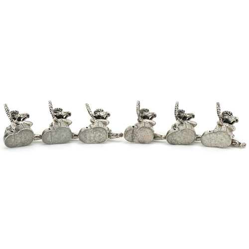 2203 - Set of six white metal place card holders in the form of Putti, 2.5cm high