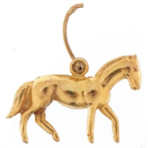 3235 - 9ct gold charm in the form of a horse, 2.1cm in length, 1.3g