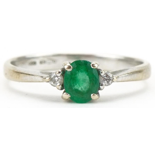 3109 - 18ct white gold emerald and diamond three stone ring, size G, 1.8g