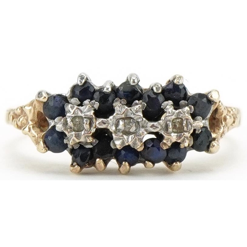 3107 - 9ct gold diamond and blue spinel triple flower head ring with naturalistic shoulders, size J/K, 2.1g