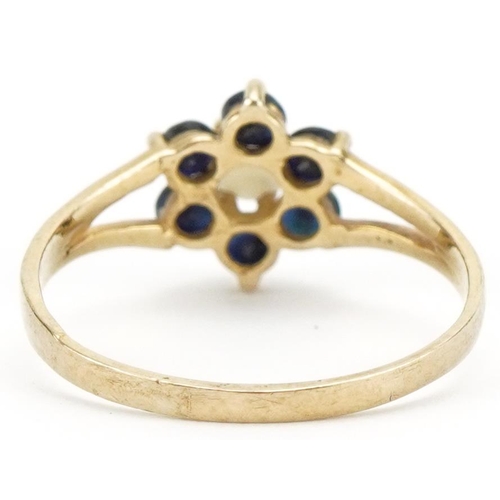 3403 - 9ct gold cabochon opal and spinel flower head ring with split shoulders, size L, 1.2g