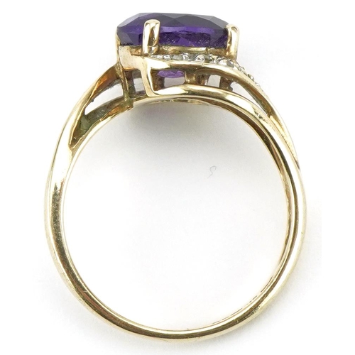 3090 - 9ct gold amethyst and diamond crossover ring, size L, 2.6g