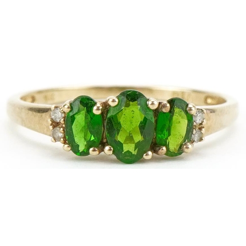 3121 - 9ct gold olivine ring with diamond set shoulders, size P, 1.4g