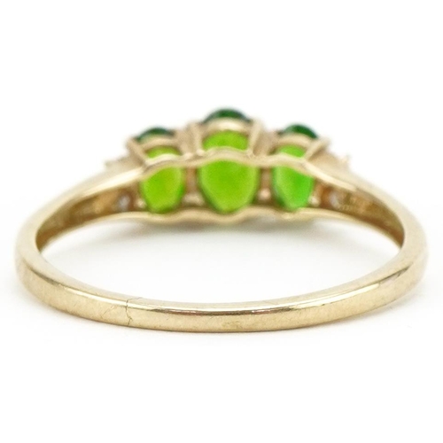 3121 - 9ct gold olivine ring with diamond set shoulders, size P, 1.4g