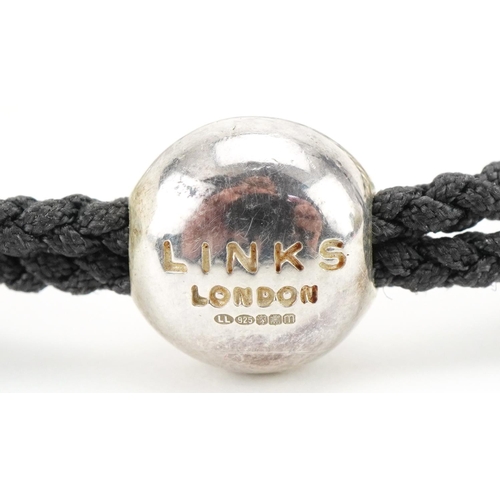 3510 - Links of London, sterling silver and cord bracelet in the form of human skulls, 20cm in length, 33.0... 