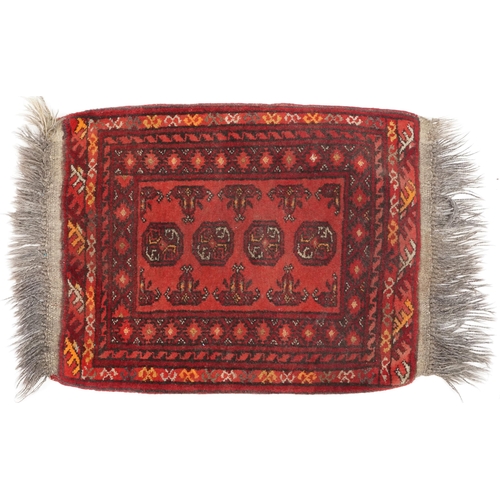 746 - Afghan rug, late 20th century the red field with a single row of guls, 65cm x 51cm