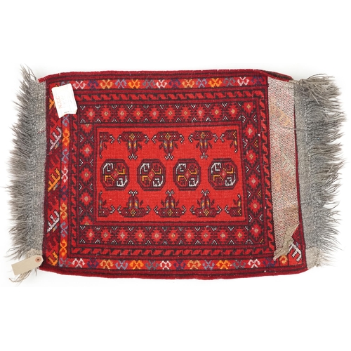 746 - Afghan rug, late 20th century the red field with a single row of guls, 65cm x 51cm