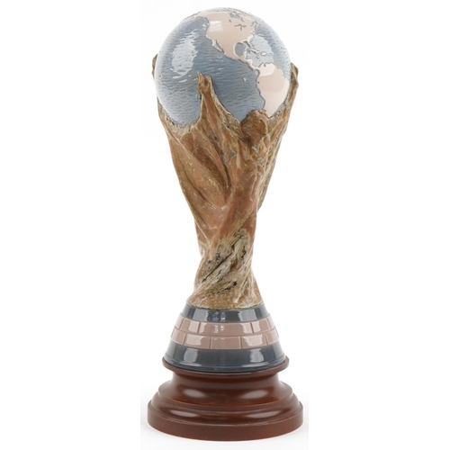 1390 - Football interest Lladro FIFA world cup trophy mounted on a wooden base, 40cms high (Collected by Di... 