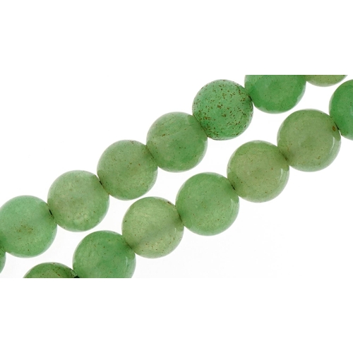 3129 - Chinese green jade bead necklace, each bead approximately 9.8mm in diameter, overall 102cm in length... 