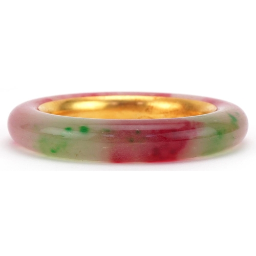 3427 - Chinese multi coloured jade and gilt metal bangle, impressed marks to the interior, 9cm in diameter,... 