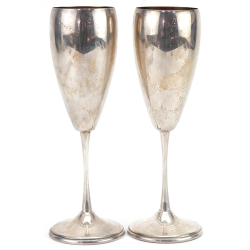 1076 - Pair of .800 grade silver Champagne flutes with gilded interiors, 19.5cm high, total 213.0g