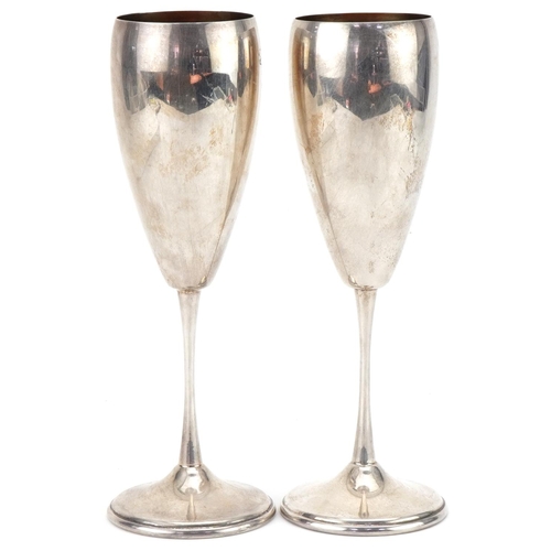 1076 - Pair of .800 grade silver Champagne flutes with gilded interiors, 19.5cm high, total 213.0g