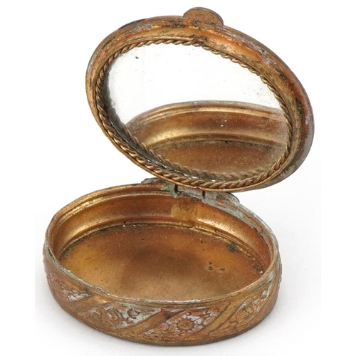 2222 - Gilt metal and enamel pill box with mirrored interior, 4.2cm wide